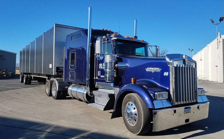 Blue Kenworth semi-truck illustrating heavy-duty trucking and custom fabrication.
